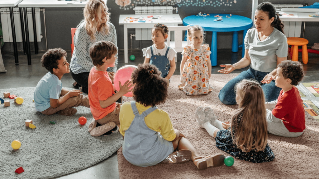 Kids sitting with their teachers