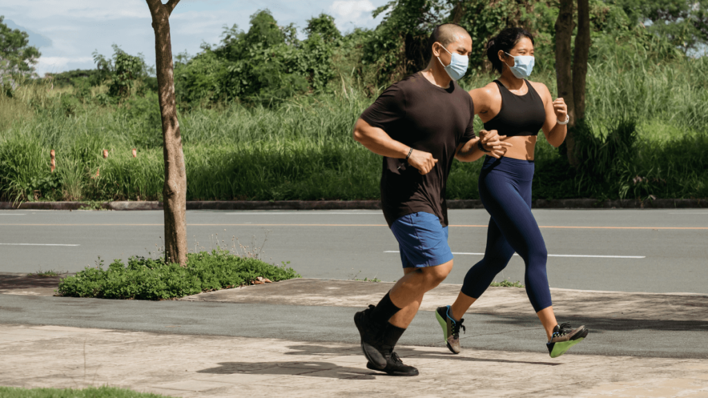 Man and Woman Running With Mask On