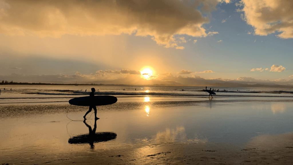 Surfers on The Beach When Dusk Falls