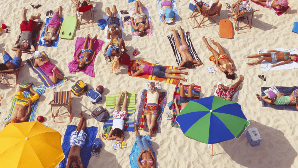 People Sunbathing at a Beach